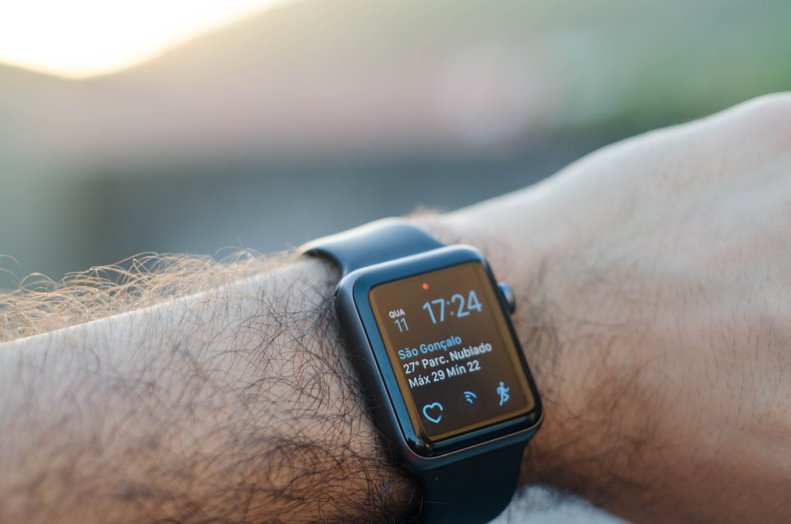sleek black smart watch with a thin black strap.