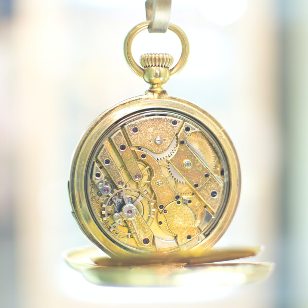 a golden skeleton watch that shows the gears inside.
