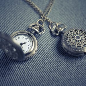 Silver antique pocket watch duo on a silver chain.