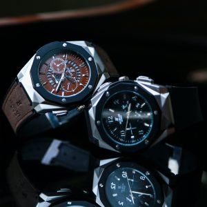Chronograph Fusion Ceramic watch by Hublot with a geometric dial, large features, and black or brown color choices.