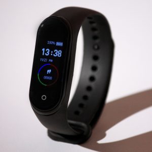 sleek black smart watch with a thin black strap.