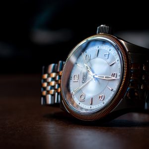 Gold and silver toned watch with a pearl dial and gold numbers by ORIS