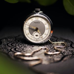 Silver pocket watch with a long silver chain