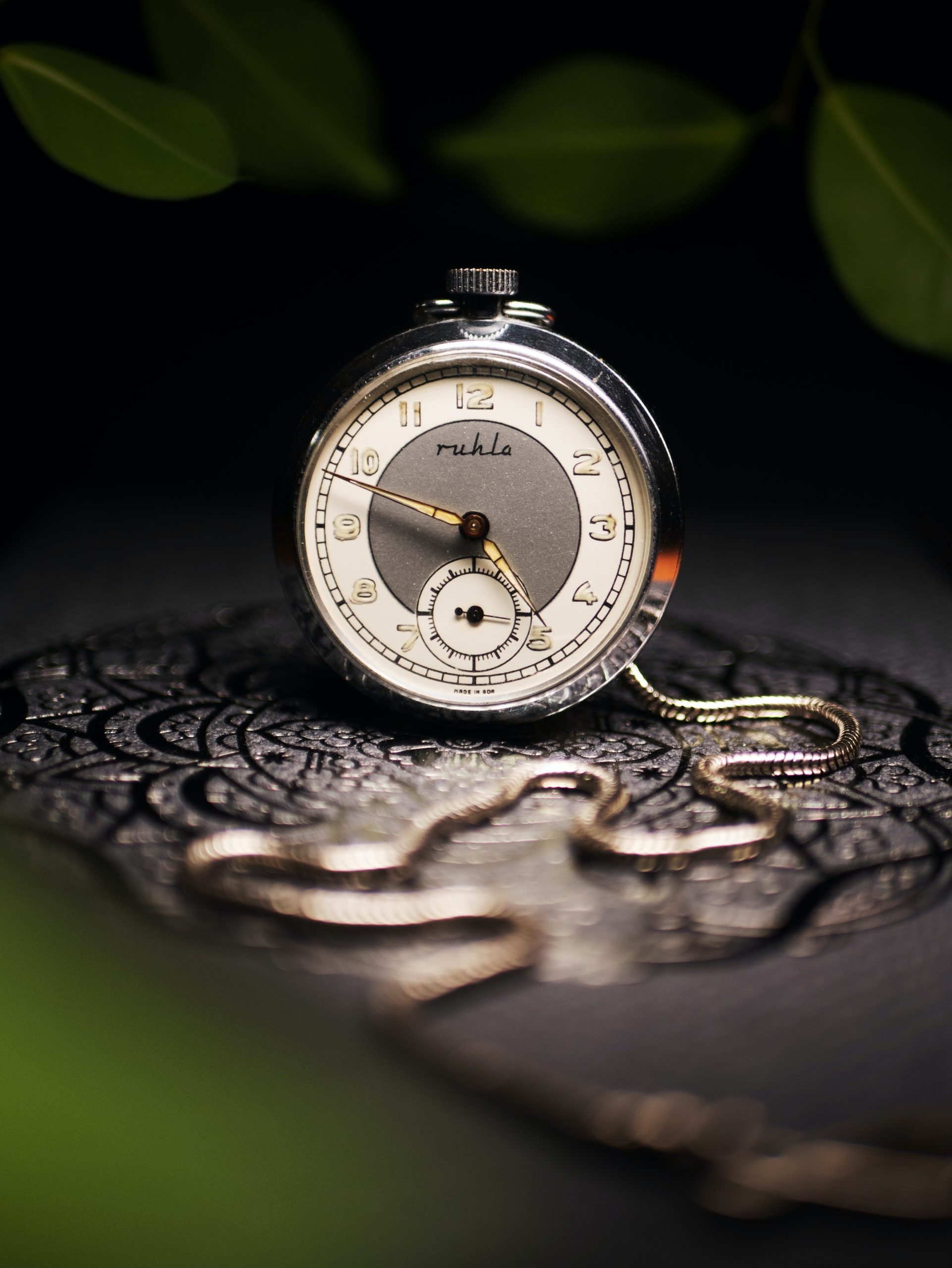 Silver pocket watch with a long silver chain